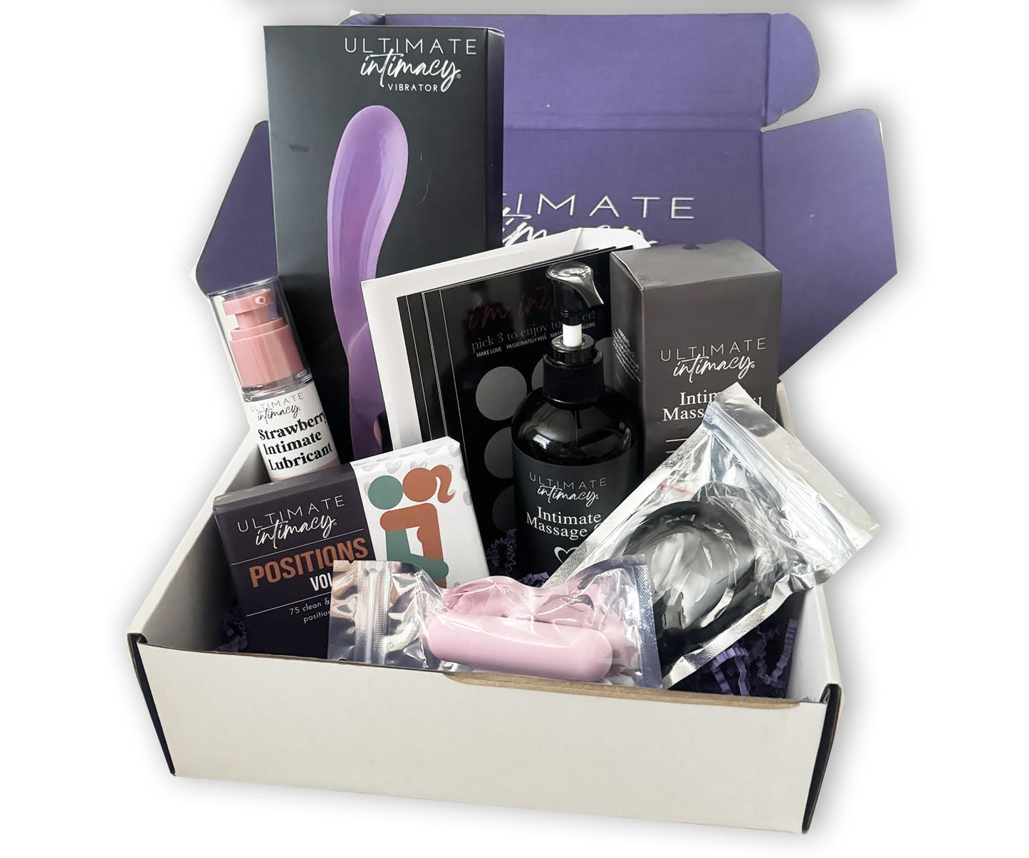 A box containing various intimate couple's toys including a suction vibrator, positions card deck, lubricant, massage oil, vibrating bullet, and scratch-off cards.